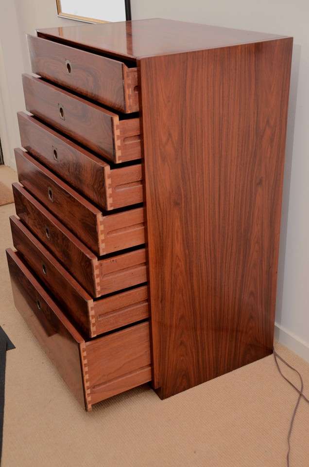 A wonderfully matched grain rosewood chest with seven drawers (bottom is a double drawer) and original recessed brass handles.