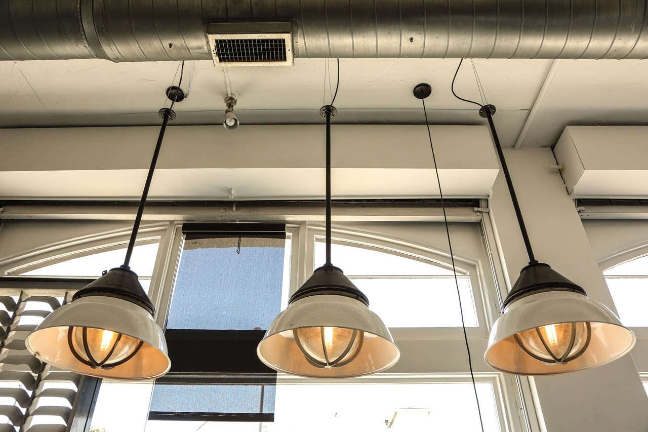 3 industrial two tone laminated metal (black and white) ceiling lamps.