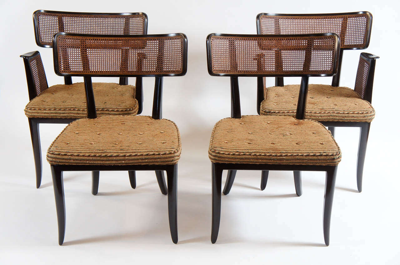 Chic set of four Klismos-inspired chairs designed by Edward Wormley for Dunbar, circa 1948.  Set consists of two arm chairs with caned backs and side-mount arms, and two side chairs with caned backs; all having upholstered seats.  Wonderful for use