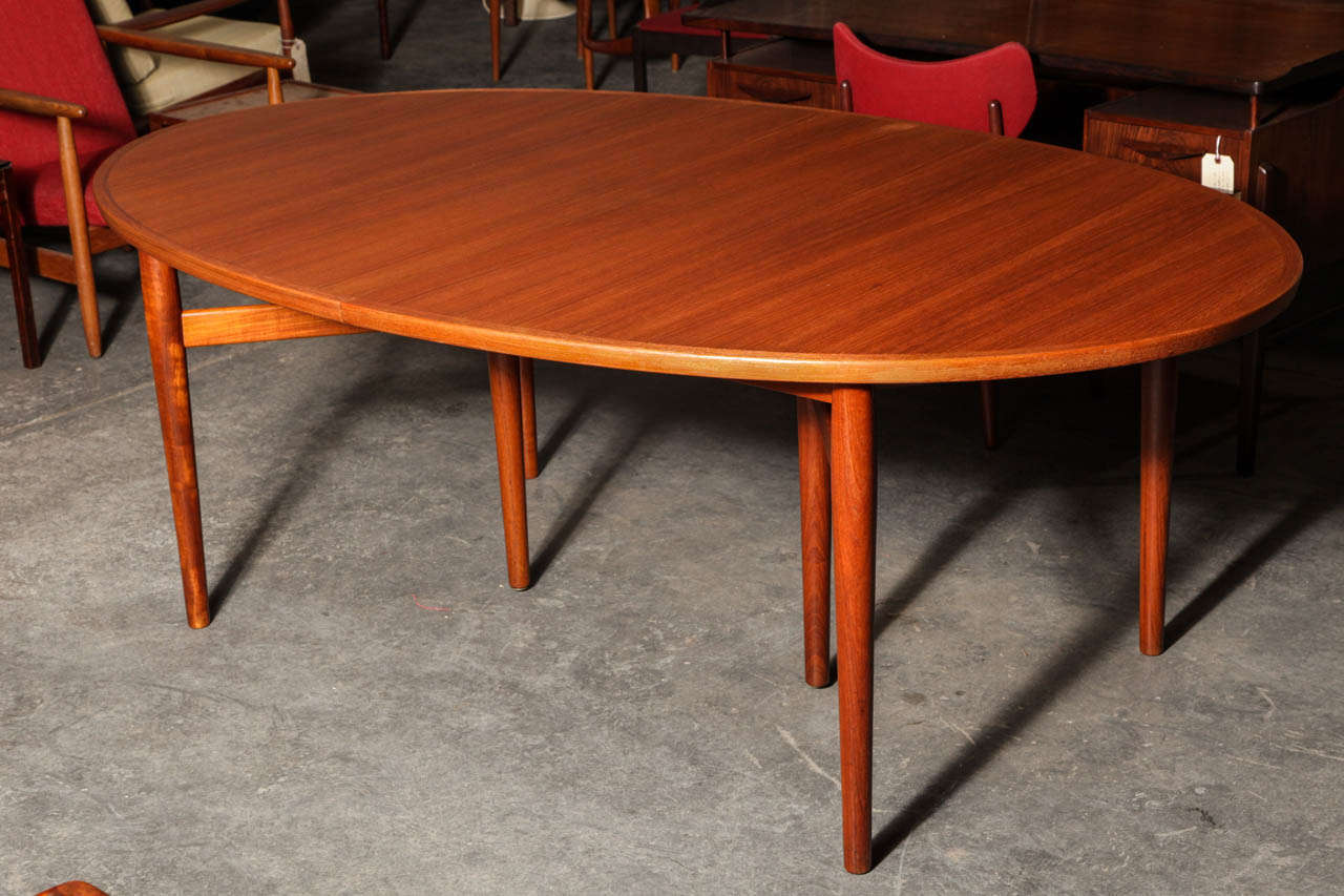 Exquisite and Rare Elliptical Teak Dining Table designed by Arne Vodder.  Features V-Shaped Legs and 2 leaves which measure 19.5