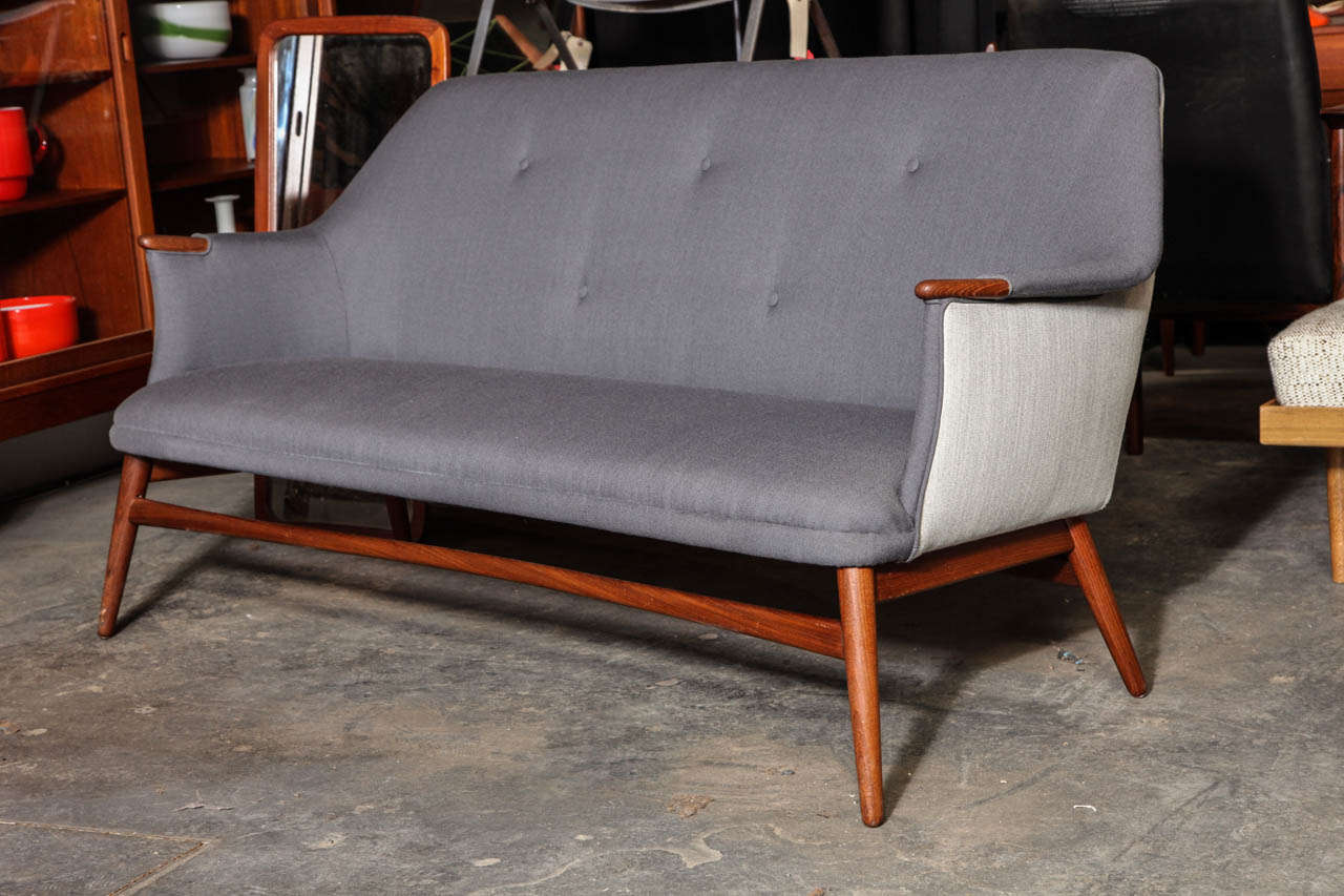 Fantastic Tufted Danish Modern Settee with solid teak legs.  Features exposed teak arm rests, and newly upholstered in gray and off-white Danish wool fabric.