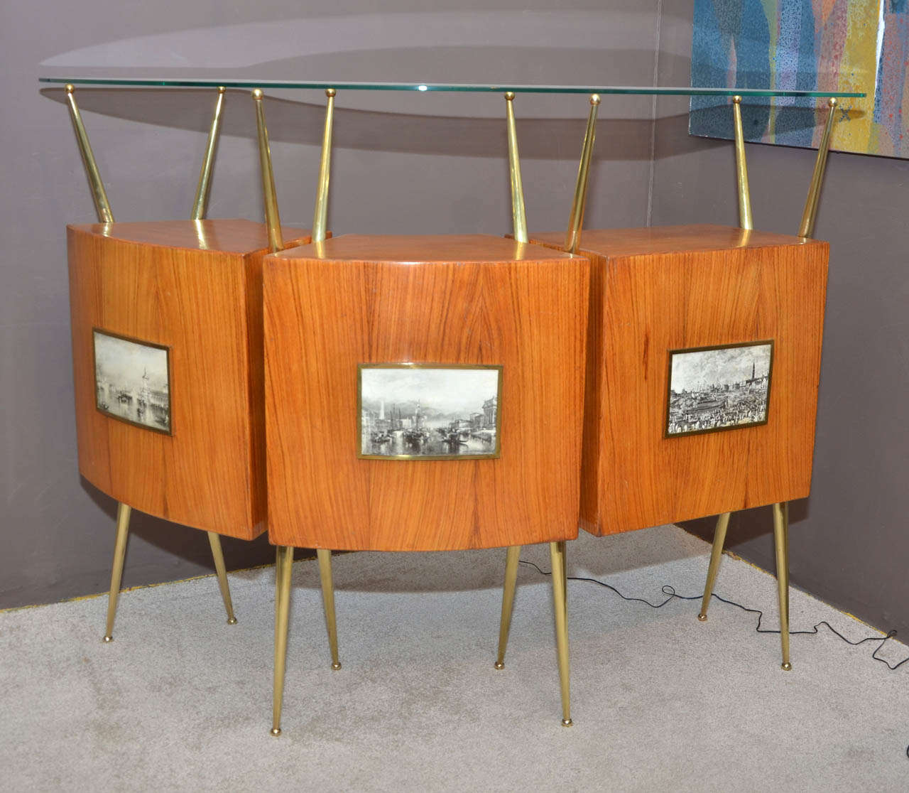 1950's Italian dry bar. Rosewood, bronze, brass and glass top. Venetian decor prints on the front. Three trunks with two drawers. Marks of drinking glasses on one place on the the wood top. Missing trunk glass shelves. Good condition. Normal wear