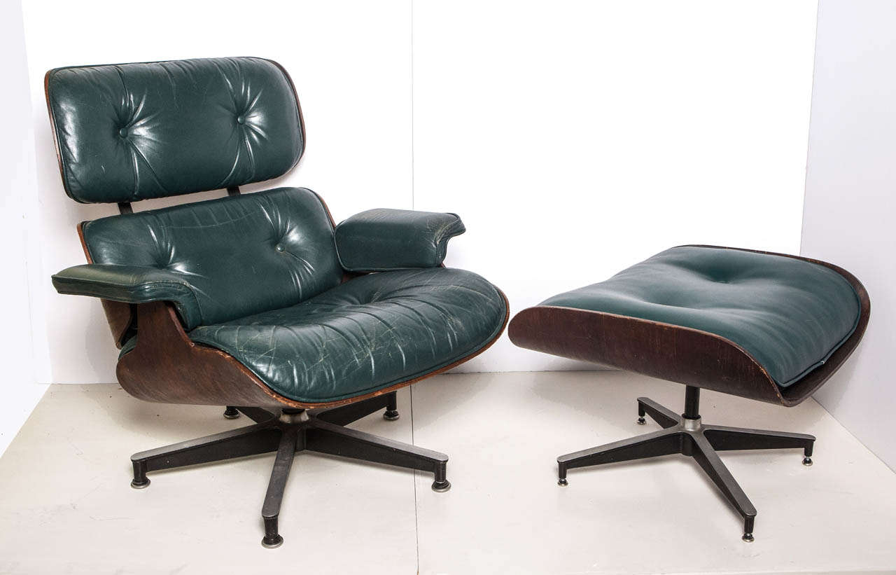 Ultra rare original Charles and Ray Eames 670 and 671 lounge chair and ottoman in hunter green with undamaged rosewood shell. Original leather on 671 ottoman was ripped and replaced to match chair as close as possible.