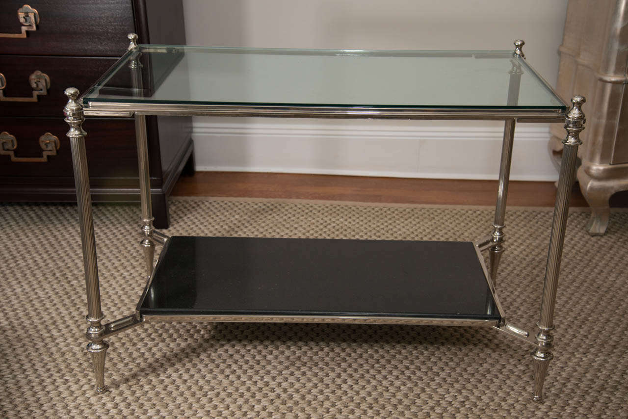 This stylish piece with glass top and lower black granite shelf can be used as a cocktail table, side table or a bar.