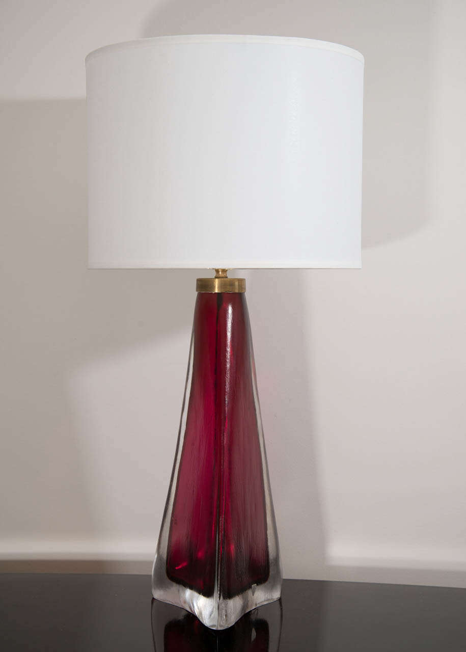 A stunning pair of Orrefors crystal lamps with a sculptural shape in a stunning garnet color, Swedish, circa 1960.