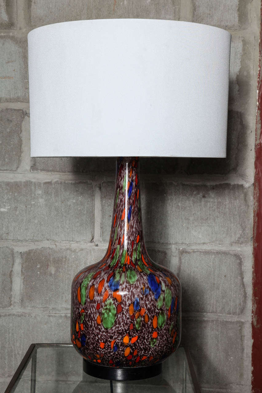 A pair of abstract Murano glass lamps. Splashes of vibrant color thoughout, on  a dappled dark mocha and white background. 21 inches tall. 8 inches wide. Shown but not included shade is 16x16x10,  overall height  31 inches tall. 150 watt.LED,CFL