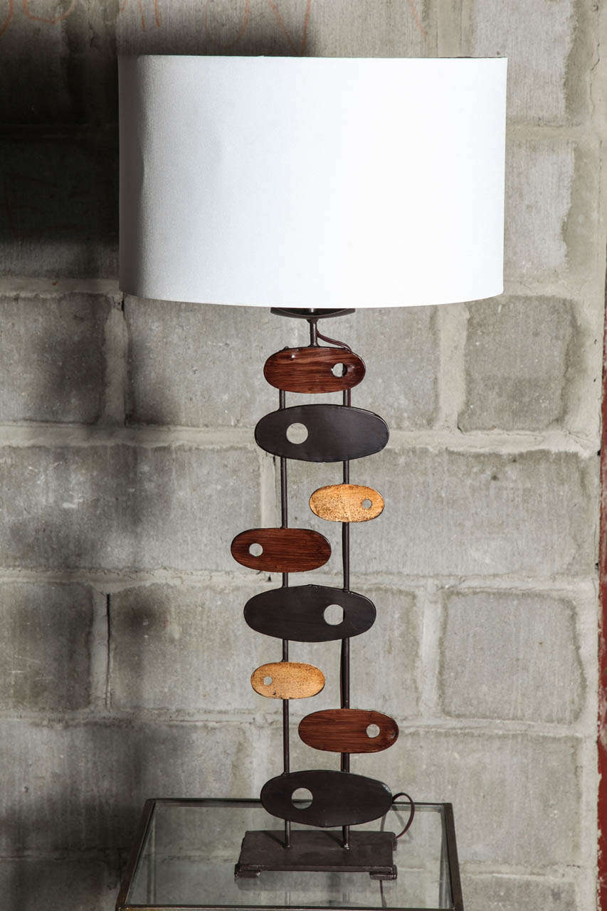 Pair of Sculptural Calder Style table lamps. Cut out ovel shapes, finished in a walnut and platinum, overall background in dark bronze. 18 x 4 inches. Shown with 16x16x 10 inch shades.( not included) Overall height 28 inches
150 watt, LED,CFL Ready.