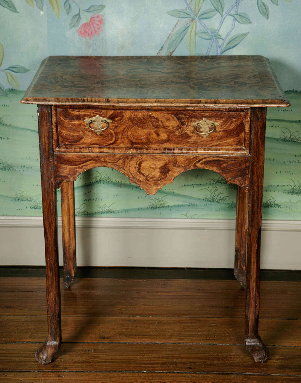 A highly unusual 18th century painted simulated burr/walnut wood table, circa 1720. The dimensions are also unusual as it stands slightly higher than usual at 30 inches high with legs terminating in very abstracted hoofed feet. This is a charming