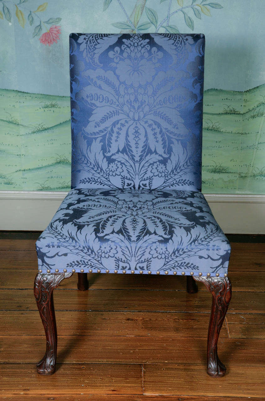 Very elegant George II upholstered side chair ca. 1740. Mahogany cabriole legs terminating in pad feet. The legs and feet are intricately carved, we believe originally but there is always a slight possibility later. The chair has been newly