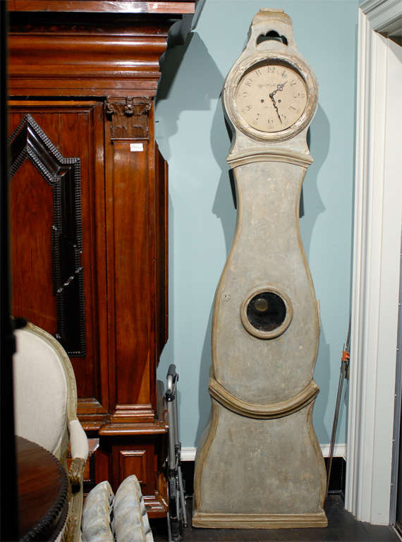 This 19th century Swedish clock, commonly referred as a Mora clock, is quartzed for excellent timekeeping. The front belly of this clock is one piece, a door with a pearl shaped glass window. Above the head is a hollow crown that calls to mind