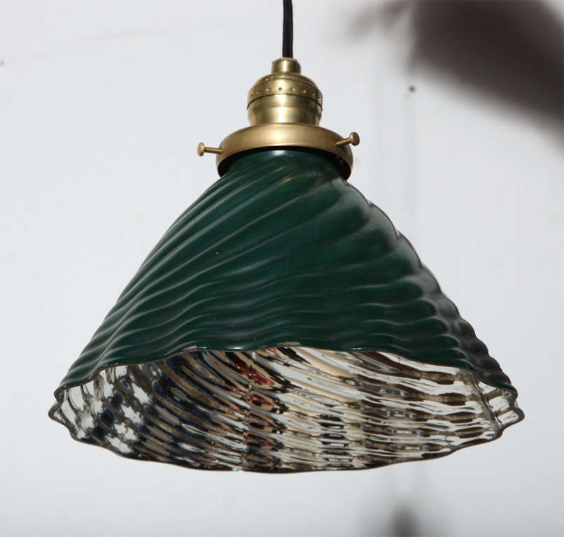 Early 20th Century Scalloped Hanging Lamp by Curtis Lighting utilizing their trademark X-Ray shade. Featuring a Dark Green scalloped swirl pattern shade exterior, Silver Mercury glass interior and Brass hardware. Originally utilized out of view for