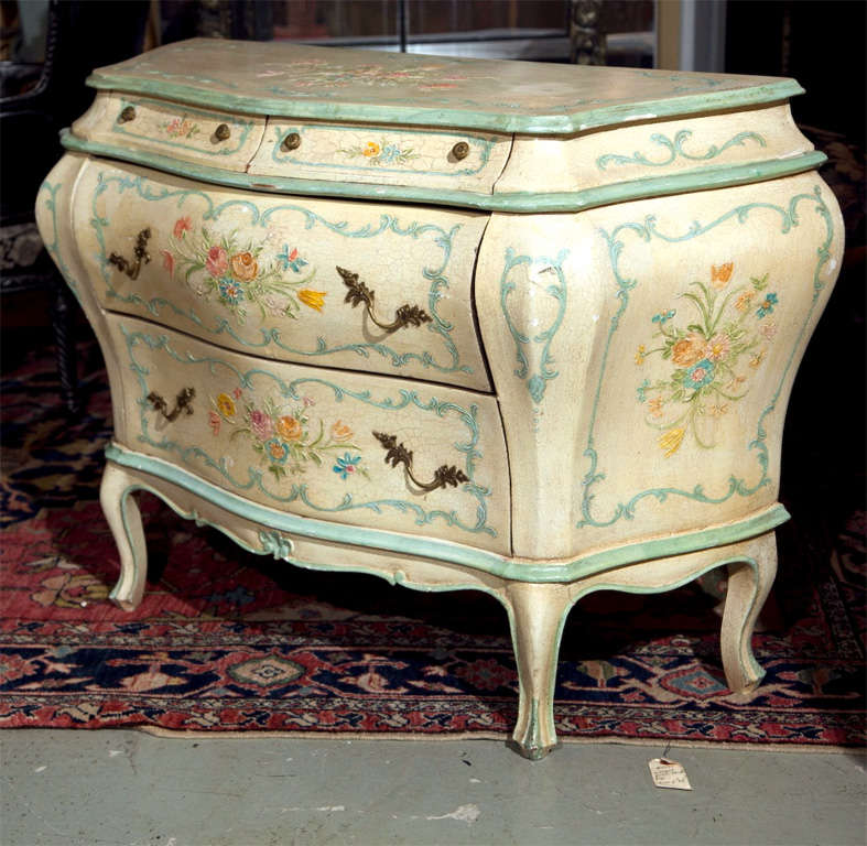 Italian venetian style painted bombe chest of drawers, 20th century, lovely distressed crackle finish with beautiful hand-painted floral detail, the serpentine top over a narrow frieze fitted with two small drawers, over two larger drawers with oak