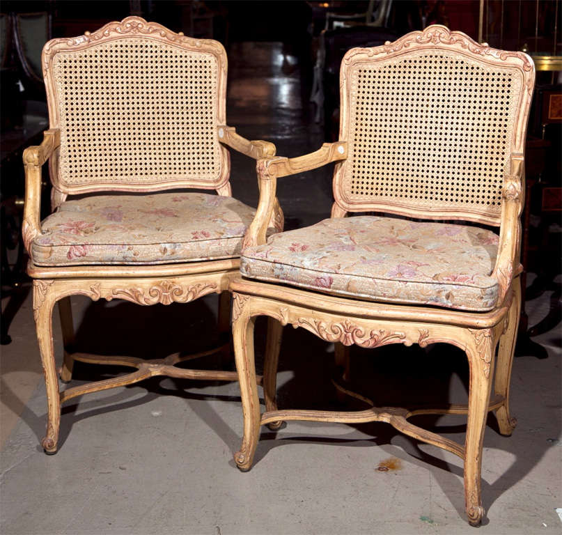 Pair of French Louis XV style armchairs, 20th century, caned back, cushioned seat, raised on cabriole legs.