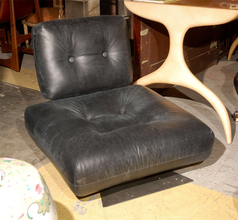 Brazil, Oscar Niemeyer leather and brushed steel lounge chair and ottoman, unmarked, provenance: PCF Headquarters, Paris