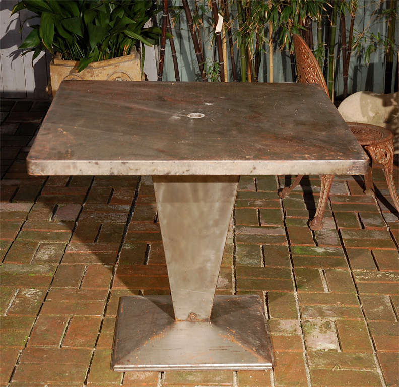 Italian art deco square top metal table on tapered pedestal base. Can be used as an occasional table, garden table, or game table.