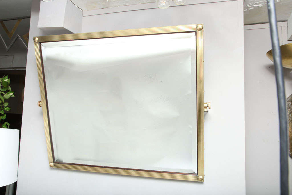 An aesthetic adjustable brass wall mirror.
  England 1880's