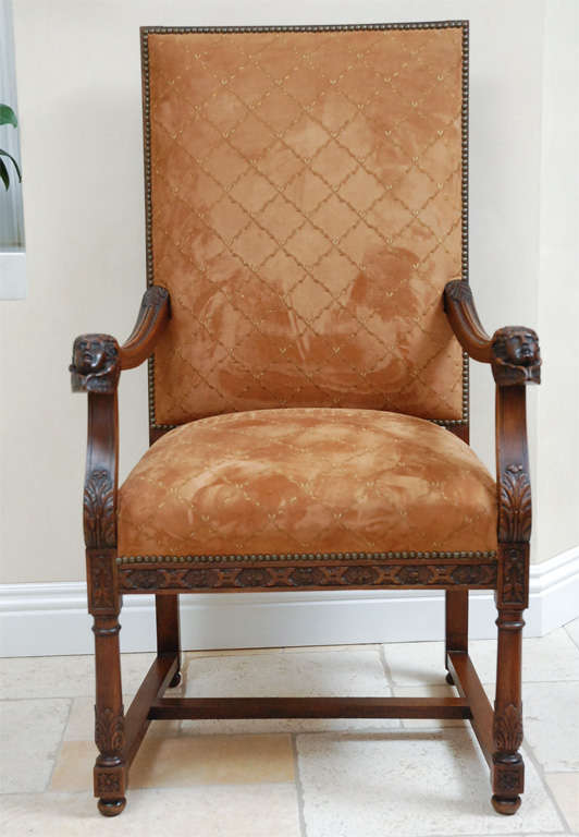 19th century Italian Finely Carved Walnut Armchairs with Cherub and Wing Motif. Upholstered in Saddle Colored Stitched Leather.