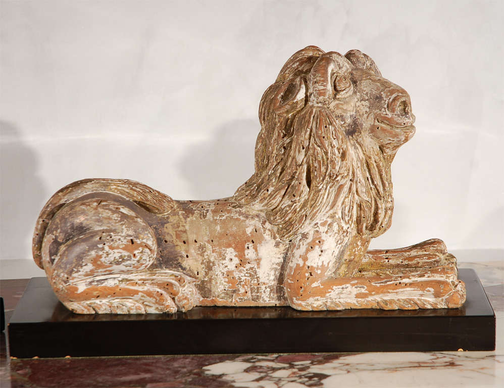 Sehr seltener, geschnitzter, mythologischer, liegender Löwe aus Lindenholz, wahrscheinlich italienisch.  Auf Sockel montiert.