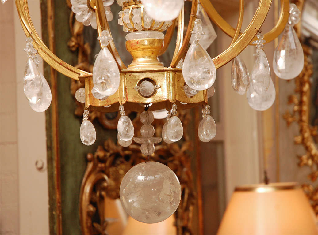 22-karat yellow gold rock crystal chandelier with very fine quality rock crystals and flower basket centre detail. Can be customized to order (finishes/rock crystal elements) and available in three sizes.