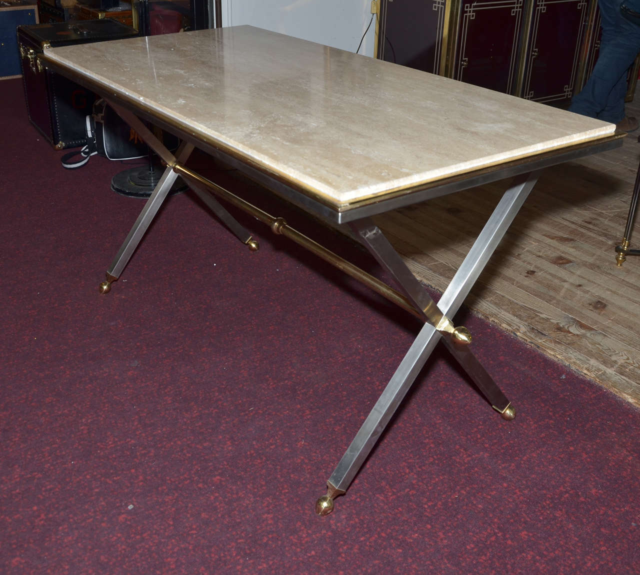 1970s console table with X-shaped base in brass, bronze and brushed steel; top surface in travertine.