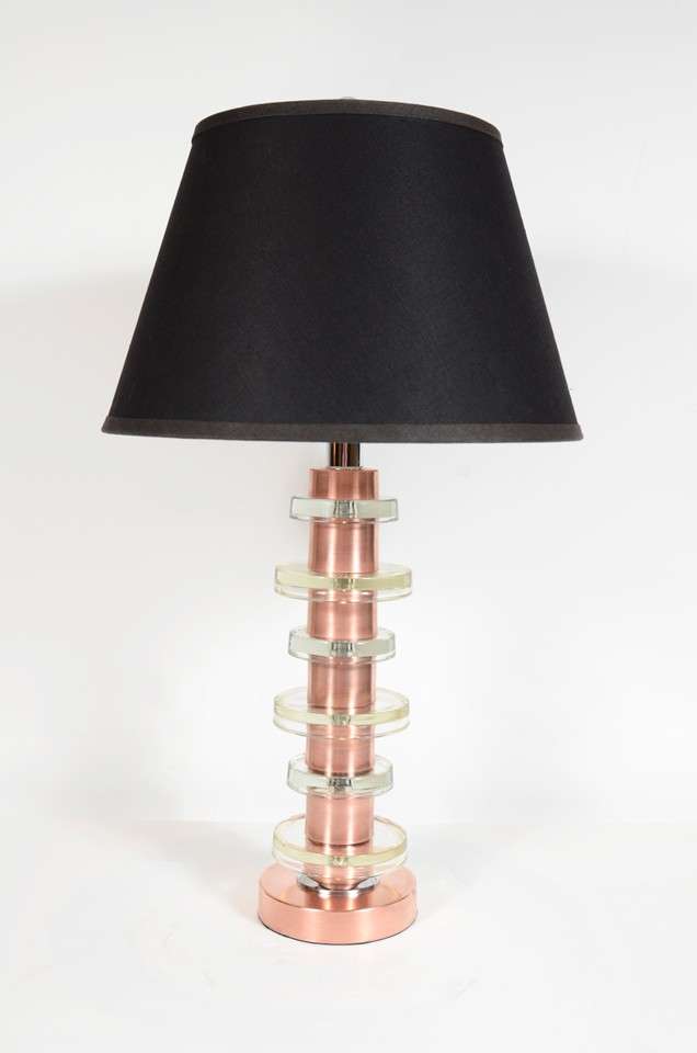 Art Deco Machine Age table lamp designed by Russell Wright. It has a brushed copper column with alternating sizes of moulded glass discs. Includes new custom shades and has been newly re-wired.