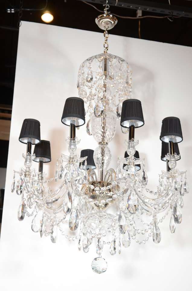 This is a truly stunning eight-arm Baccarat Chandelier with draped crystal beading, faceted fine cut crystals  and an attractively detailed upper canopy and mercury glass accent. It features a large faceted ball at the base to finish off this