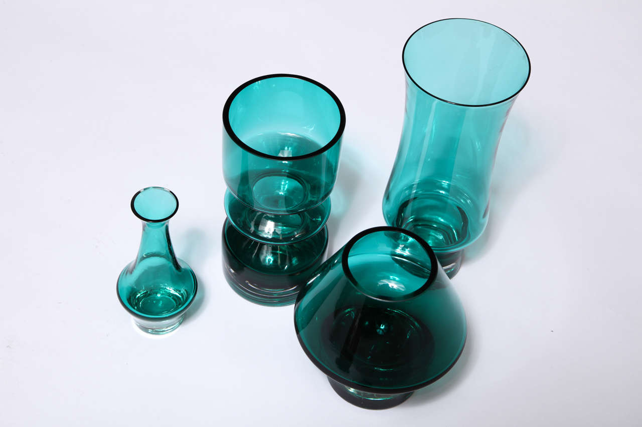 A set of 4 greenish teal sculptural glass vases. Made in Finland in the early seventies. Great as a grouping. Sold individually.

Left to right:
6