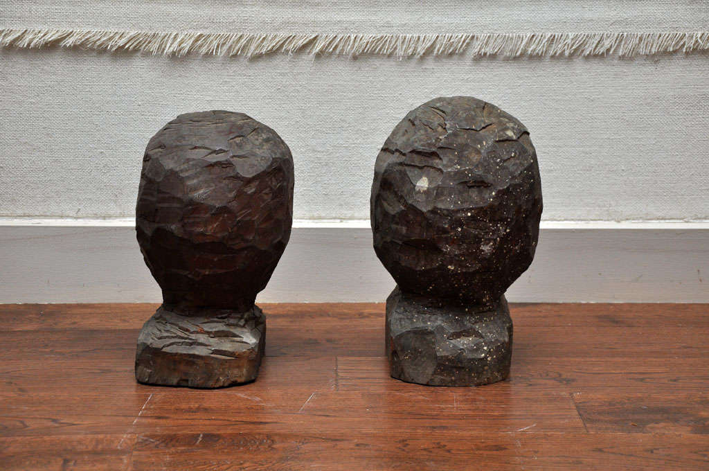 19th century primitive carved wooden studio heads. These carved heads were found in a artist studio alongside hat molds. May have been the initial stages of handmade hat mold or possibly carved as sculpture.
