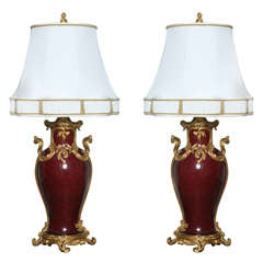 An exquisite pair of ox-blood porcelain lamps by Henry Dasson