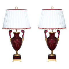 An extraordinary pair of Russian ruby red urn lamps