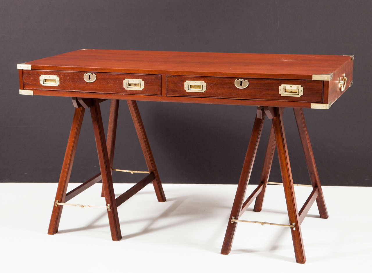Finely crafted hand-made campaign desk with inlaid brass corners and drawer pulls. Entirely of mahogany including drawer linings and underside, with hand-cut dovetails throughout. Newly refinished to original specifations. English, 1960s. 

This