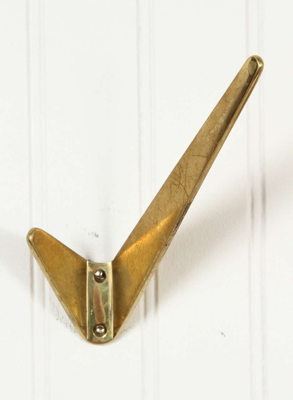 Sculptural solid brass wall hooks in the style of Carl Auböck. Made in Austria circa 1950s.
