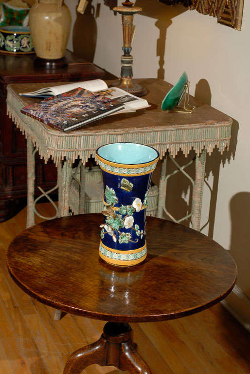 This is a stunning piece of majolica.  The vase has a relief of butterflies, vines, flowers and birds.  The background is cobalt with gold banding on the top and bottom.  The inside of the vase is a brilliant turquoise.  This vase is marked JH for