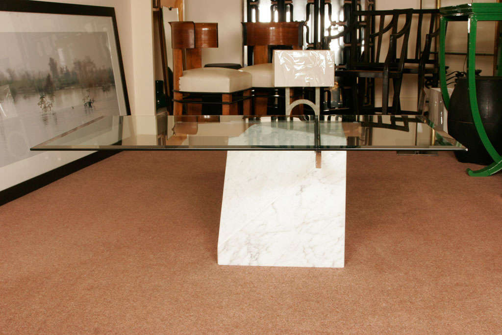 Artedi glass top table on a white marble stand