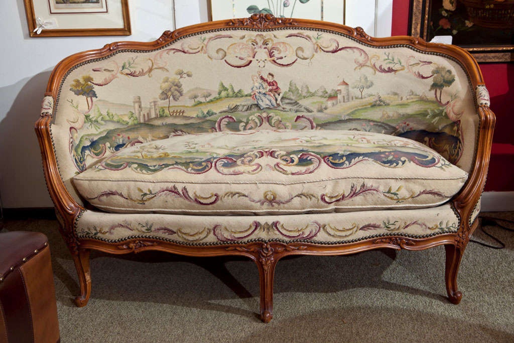 UNIQUE ONE PIECE FRENCH NEEDLEPOINT BACK AND SEAT WOVEN TO GO ON THIS SETTEE. ROMANTIC OUTDOOR SCENE- FRAME IS BEECHWOOD WITH FRUITWOOD FINISH- OUTSIDE BACK IS SOLID COLOR NEEDLEPOINT- FRENCH NAILHEAD TRIM ON FRONT