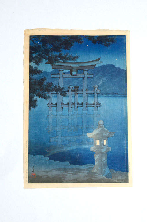 Woodblock print by Kawase Hasui of a stone lantern lighting Miyajima