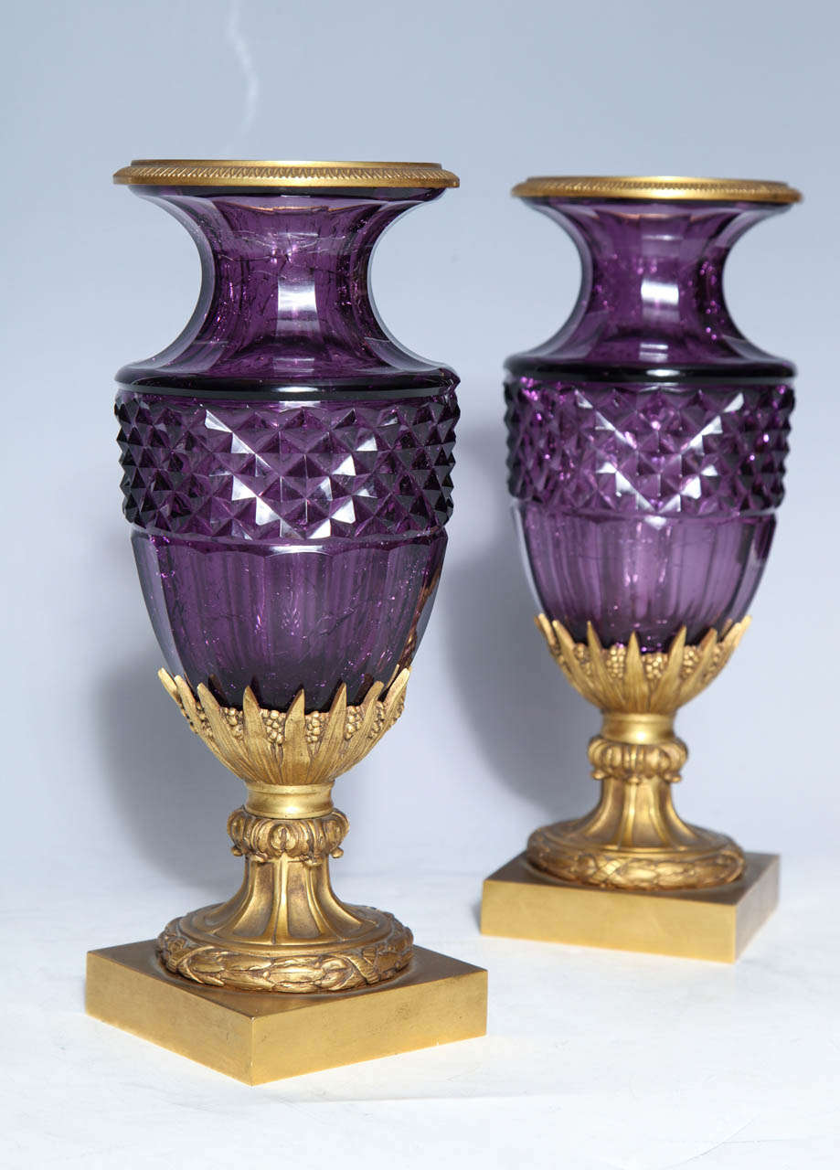 A fine pair of Antique Russian of Amethyst cut crystal vases in doré bronze mounts. As so often happens, the artisans of the 19th century turned to nature for inspiration. Here we see the fire of precious amethyst captured in glass. The glass was