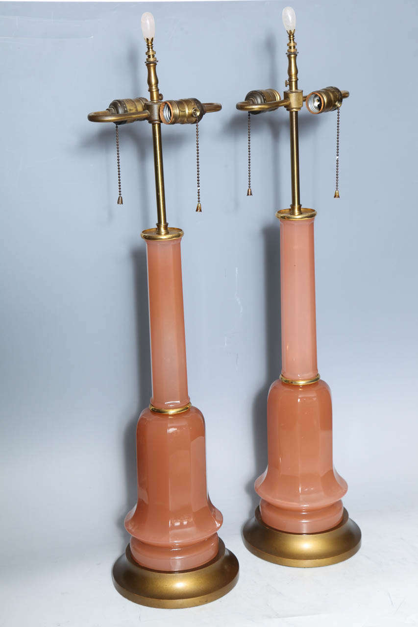A Magnificent Pair of Antiques French Pink Salmon Lamps with Rose Quartz Finials. With Elegant Flared Bronze bases, Finely Wrought and Embellished Finials and Highly Polished French Opaline Glass body, these lamps are an excellent example of the