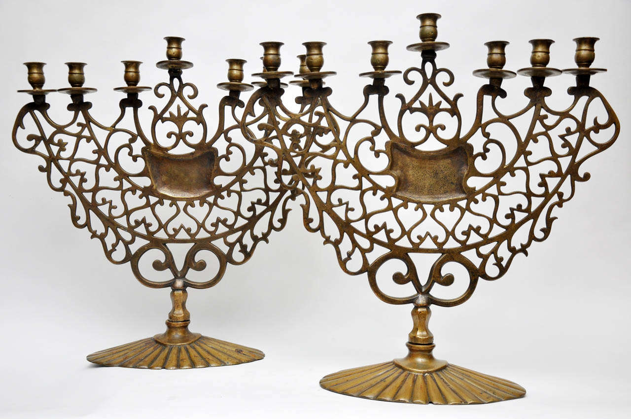 Pair of 19th century bronze seven-light Synagogue Menorahs. The menorah is of the oldest symbols of Juaism. The Kohanim, the hight priests, would light the menorah with olive oil in the temple every evening. The Menorah appears in the coat of arms