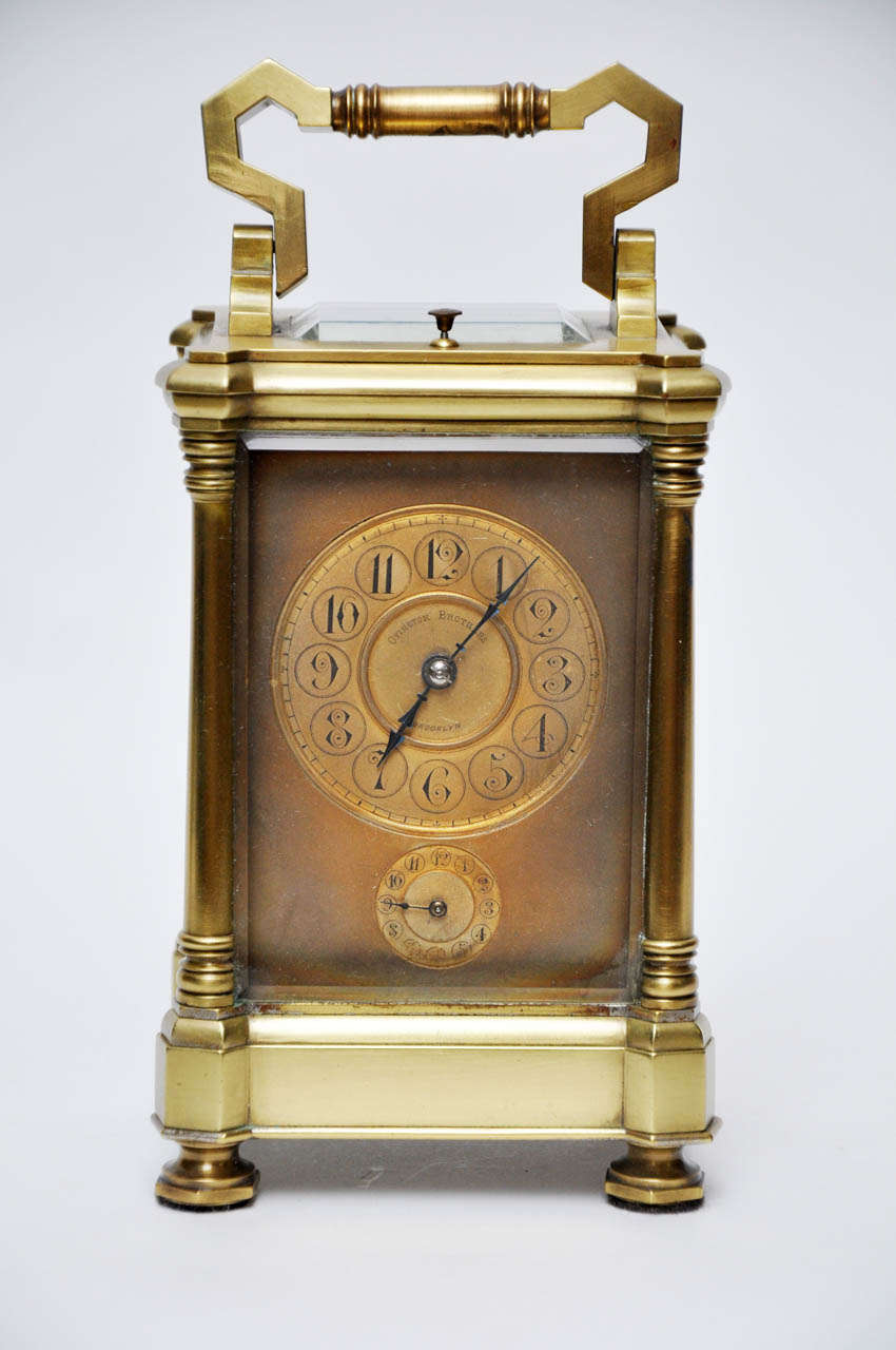 A rare brass carriage clock that not only strikes the hour and half hour, but has an alarm to strike the hour. Clocks like this one were used on long trips by carriage or train. The solid brass case has a column at each corner to hold the beveled