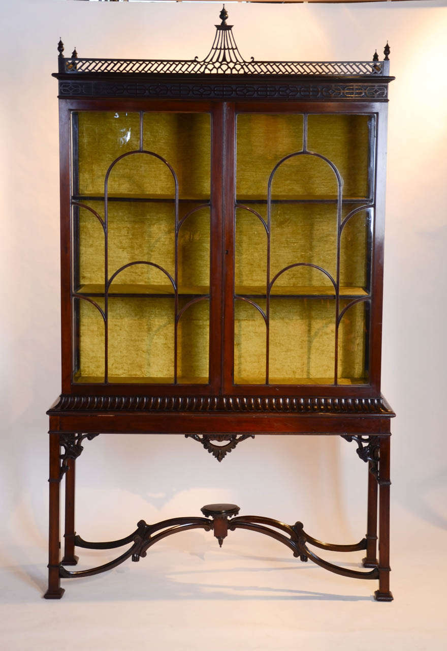 An impressive mahogany centennial display cabinet in the Chinese Chippendale manner.