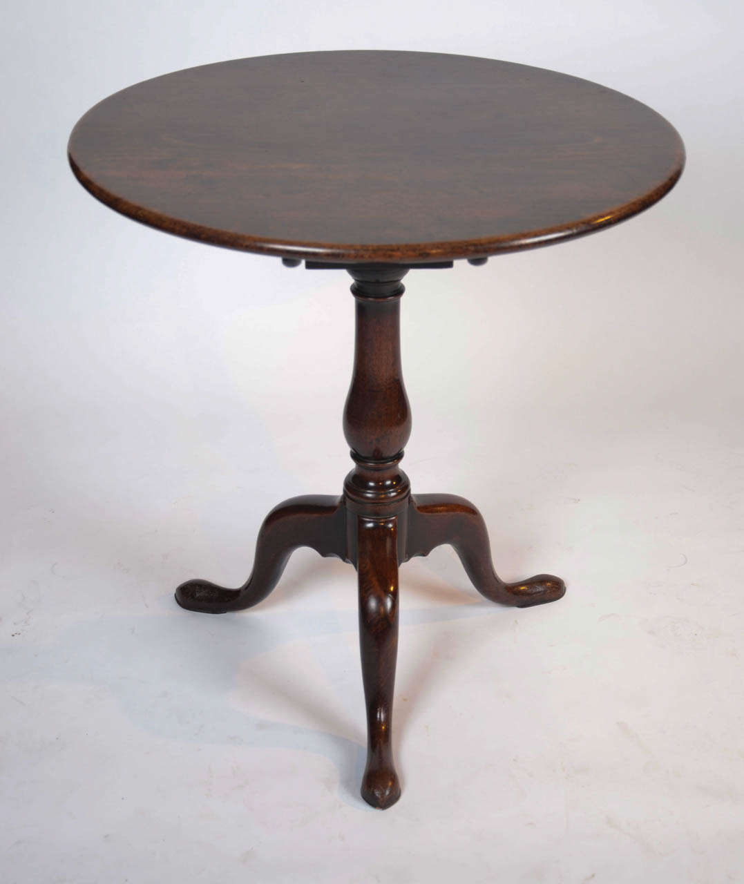 A fine George II period mahogany tea table with birdcage mechanism, the columns of which are turned to replicate the main stem.