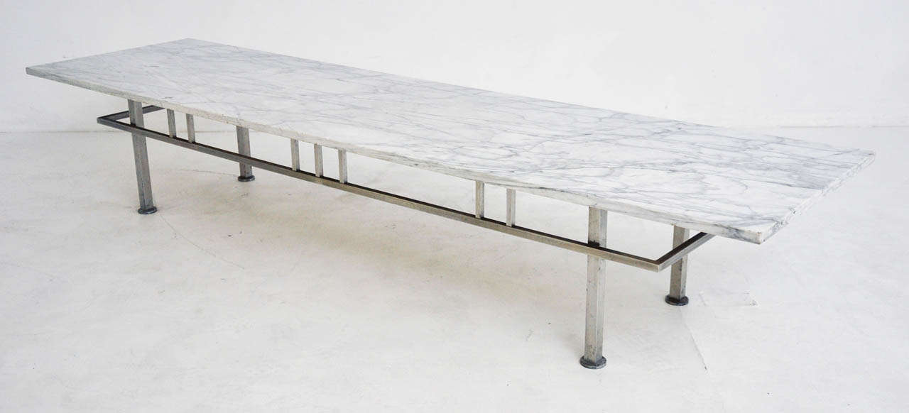 Marble top cocktail table over brushed metal base.