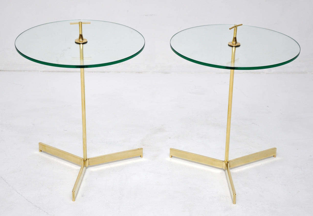 Pair of tripod snack or drink tables. Brass with glass tops.