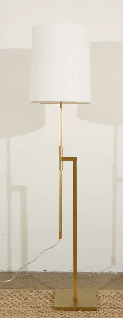 Elegant and graceful, this Laurel floor lamp features a polished square brass frame with a square base and an adjustable telescopic height, varying from 44