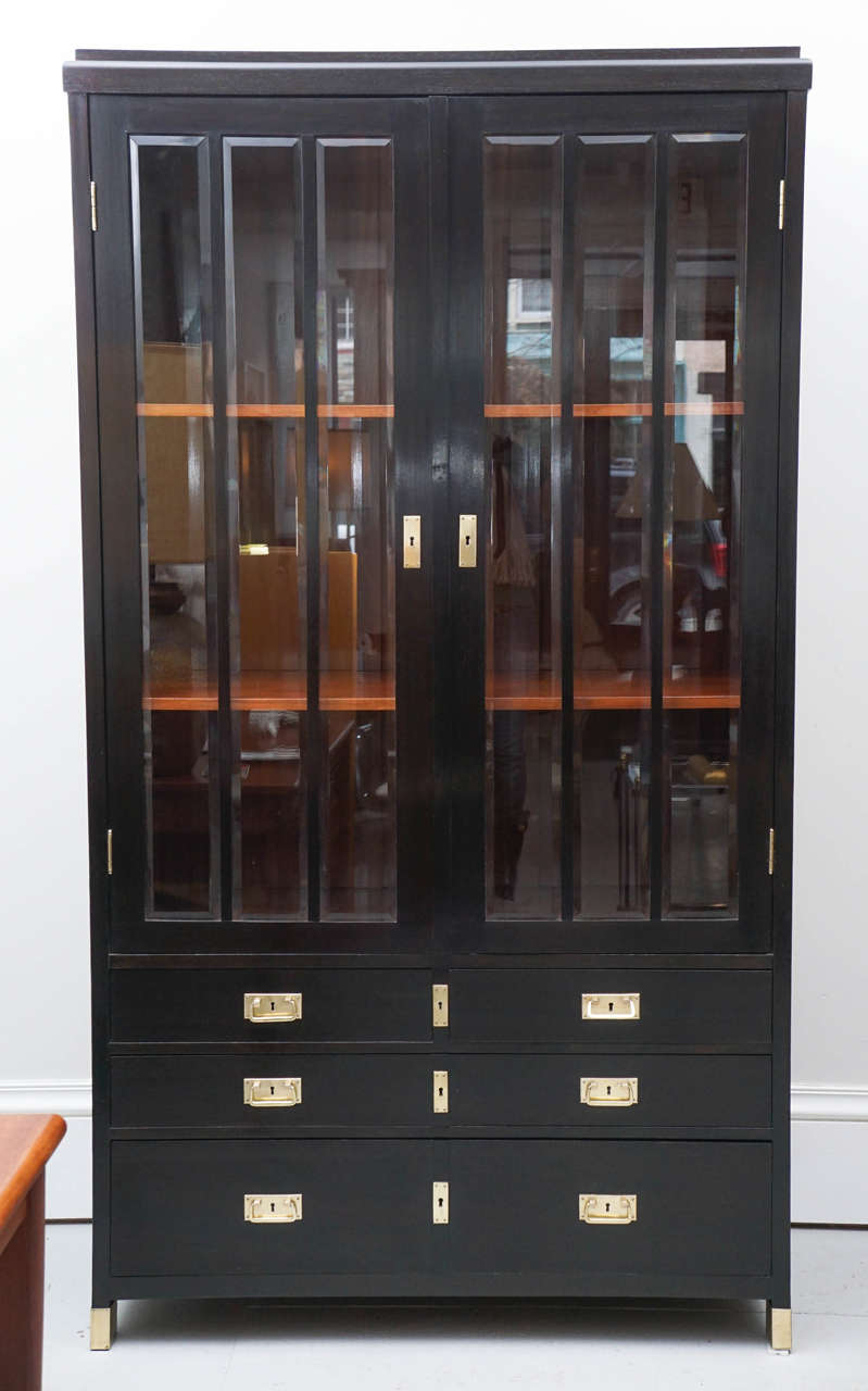 A very handsome 1940s Austrian cabinet with glass doors and six drawers. The cabinet would serve well in any room. The piece has been recently re polished.