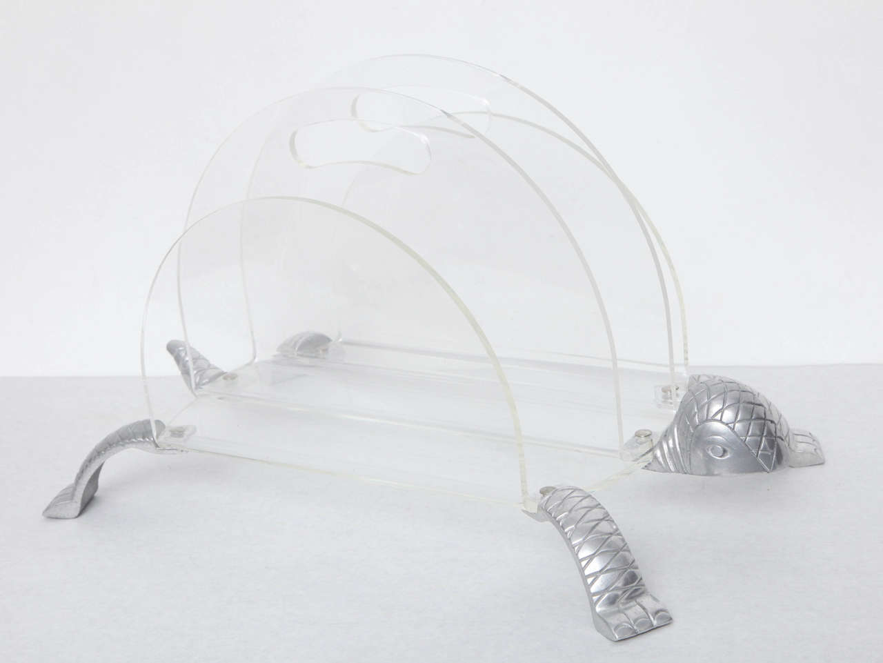 Lucite and aluminium turtle magazine holder, pierced with carrying handles.