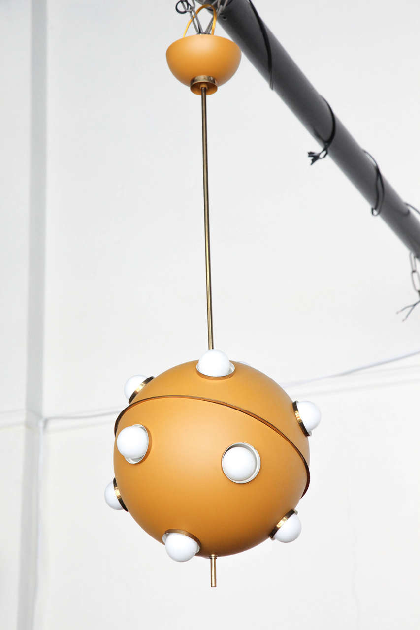 Exciting modernist chandelier or pendant made in Milan, 1959 designed by Oscar Torlasco made by Lumi. Fixture in original mustard color finish has 12 lights, unusual rare form.