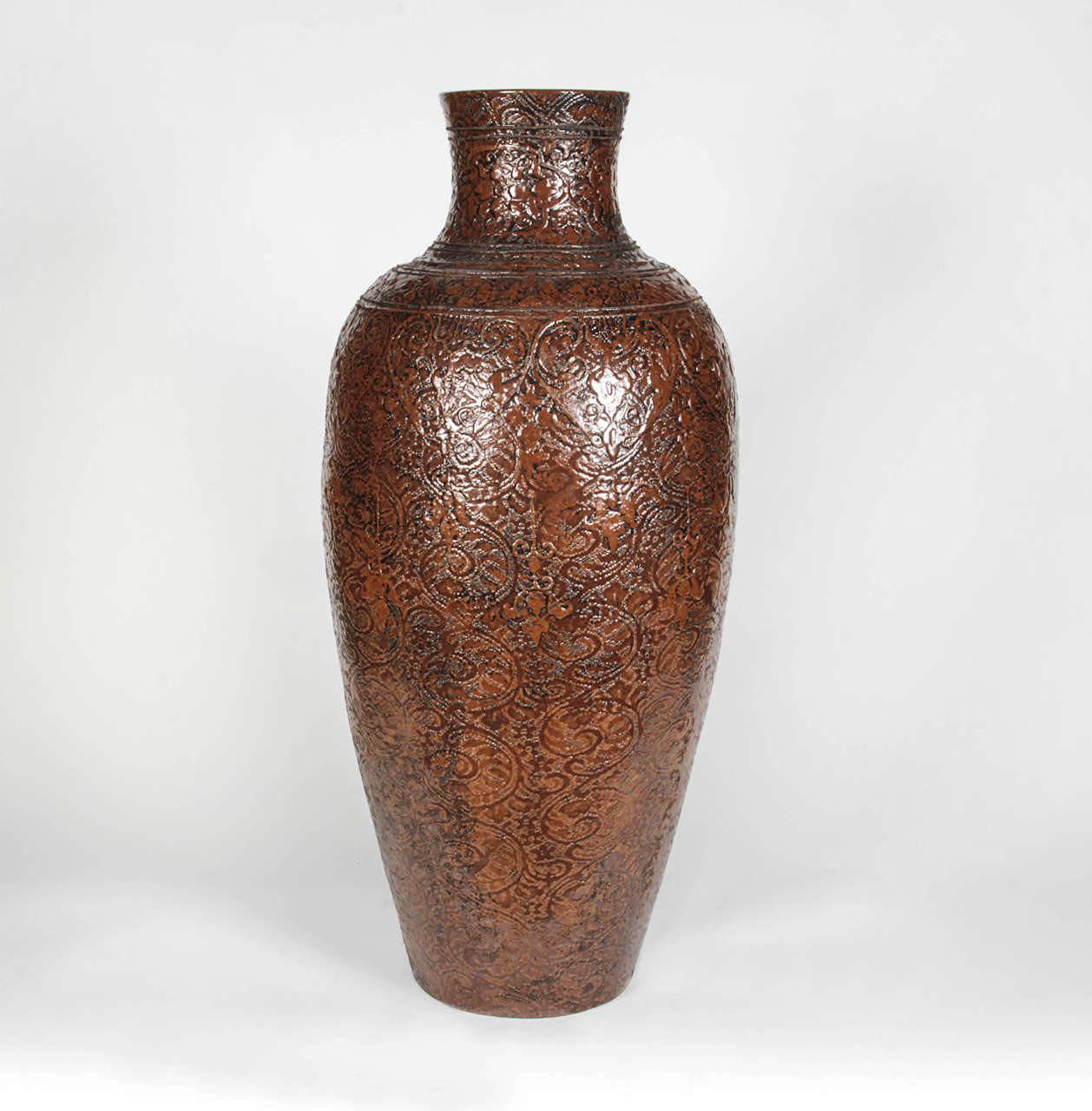Brown and Black Thai ceramic vase with scroll work in shiny finish. Curated and personally selected by Donna Karan for her Urban Zen brand.