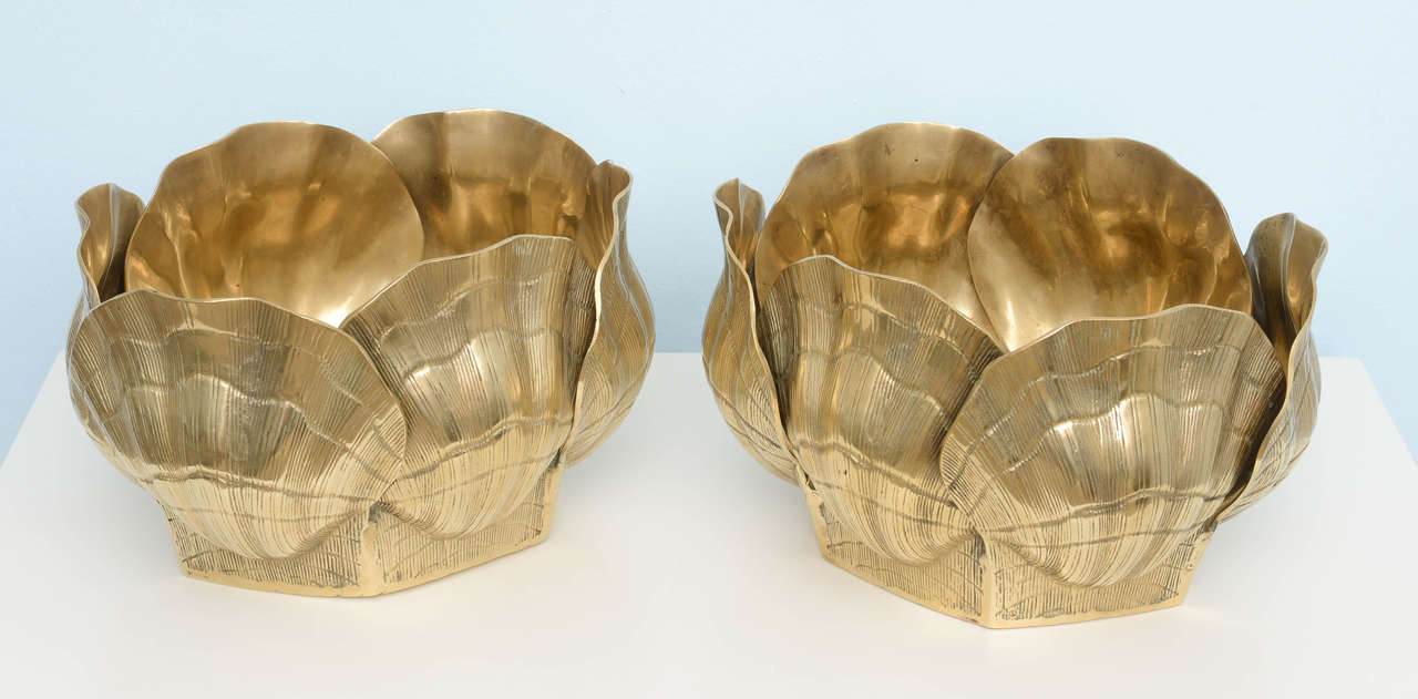 Solid pair of 1970s vessels could be used as planters or bowls. These are made of solid brass and are quite heavy. Great for plants or also as a bowl. Quite amazing for a contemporary modern or seaside interior.